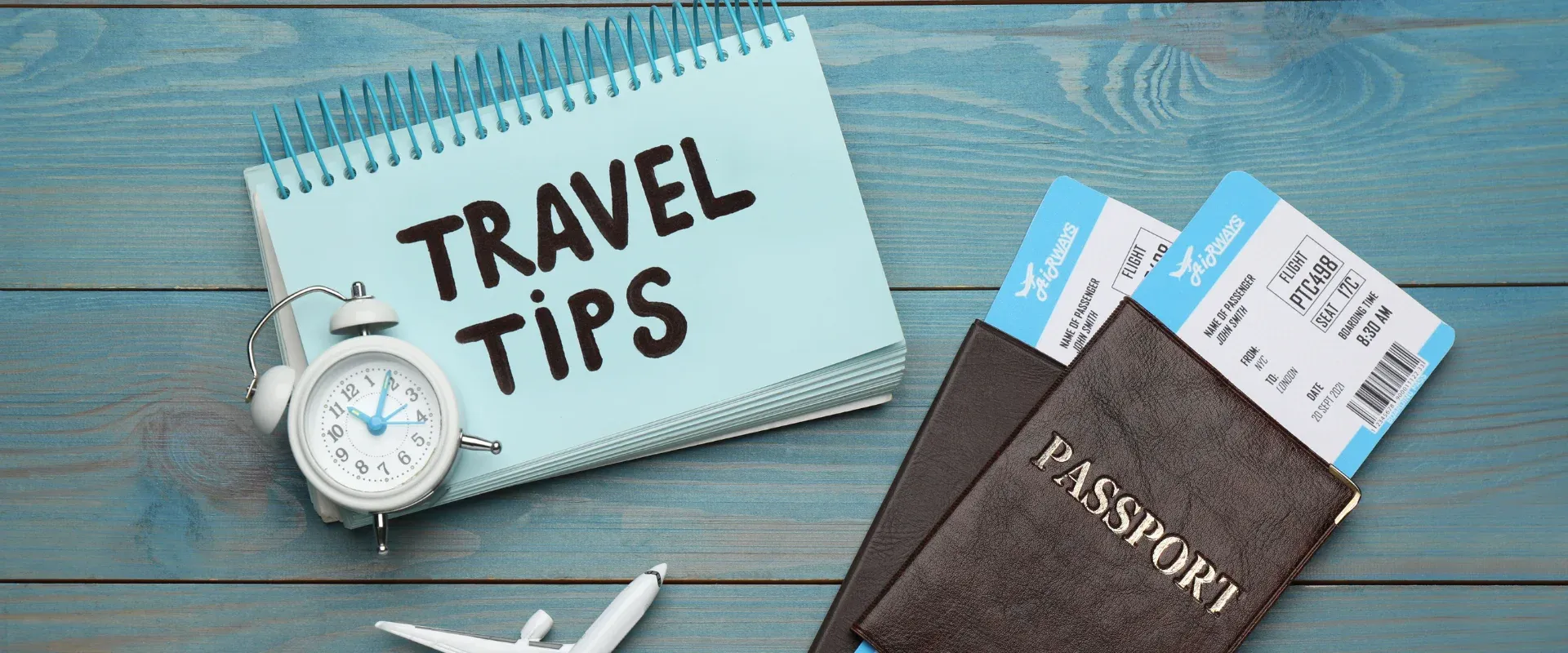 Travel Tips concept sketch , Airline tickets, passport, sunglasses and camera on wooden desk