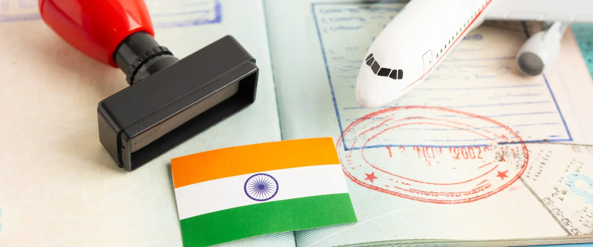 Approved Stamp visa and passport with India flag document to immigration at airport in country.