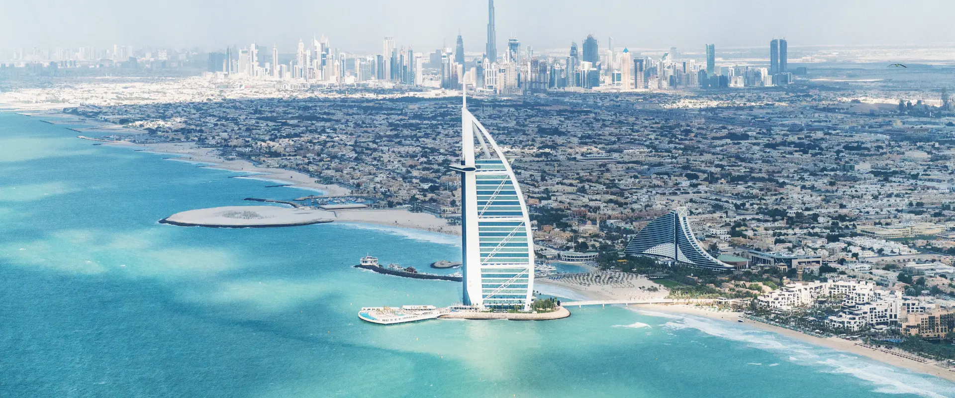 Burj Al Arab is a luxury 5 star hotel built on an artificial island in front of Jumeirah beach. Helicopter view